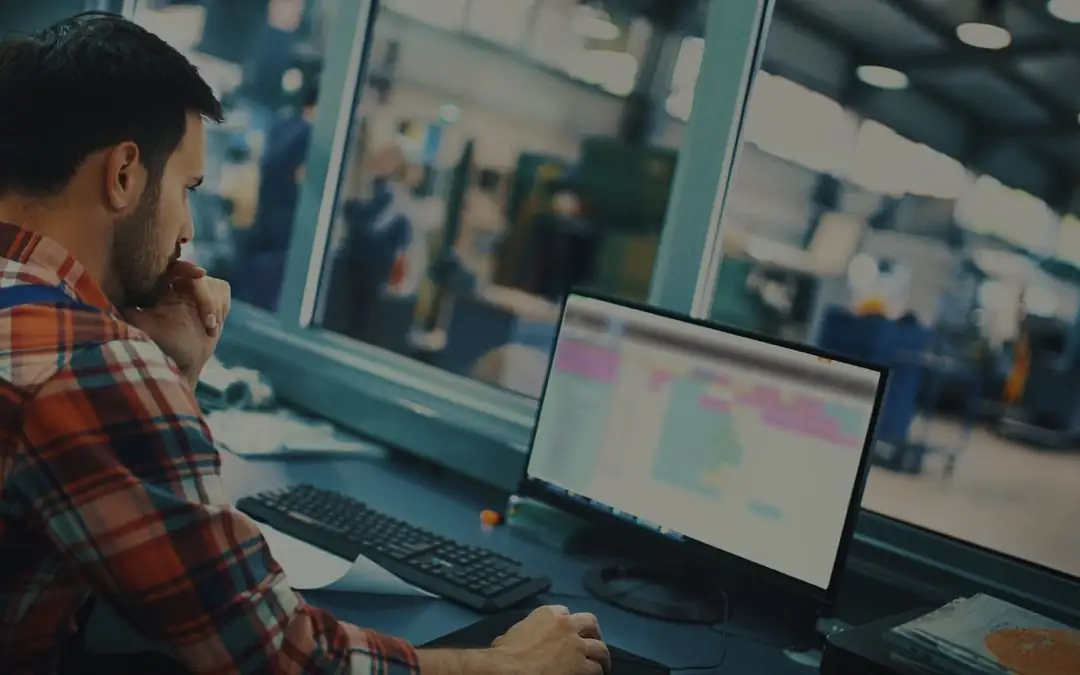 An engineer checking production software in a factory